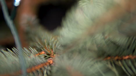The-Tiny-Leaves-Of-A-Christmas-Tree-With-Hanging-Decorations-In-A-House---Slow-Motion