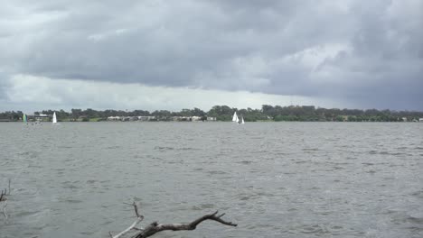Sail-boats-on-river-on-windy-and-cloudy-winters-day