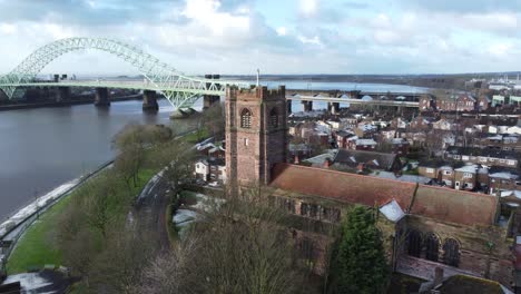 Aerial-view-industrial-Jubilee-bridge-small-town-frosty-church-rooftops-neighbourhood-North-West-England-left-orbit