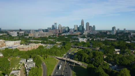 Cars-Driving-on-Highway-with-Charlotte,-Skyline-in-Background