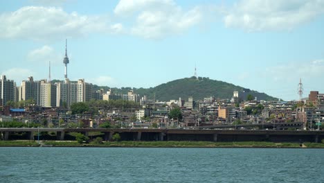 N-Seoul-Tower-at-Namsan-Mountain,-Yongsan-District-City-Panorama-View-from-the-Bank-of-Han-River-daytime-static