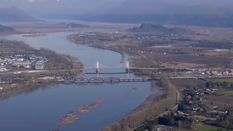 Aerial-View-Of-Pitt-River-Bridge-And-Canadian-Pacific-Railway-Spanning-Between-Port-Coquitlam-And-Pitt-Meadows-In-British-Columbia,-Canada