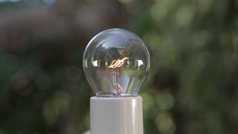 Close-up-on-Incandescent-Light-Bulb-Flickering-from-Darkness-to-Bright-Blurred-Background,-4K