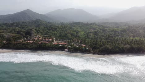 Beach-waves-and-mountain-jungle-haze-at-quiet-resort-hotel-in-Colombia