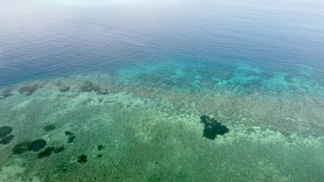Rising-aerial-of-huge-coral-reefs-on-the-coral-triangle-in-Timor-Leste,-South-East-Asia
