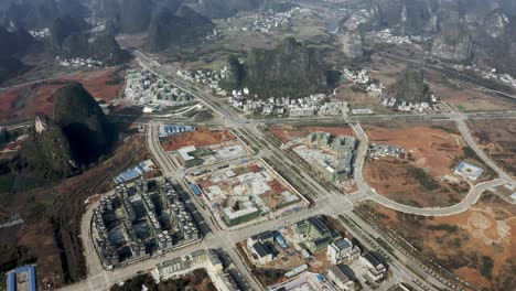 Chinese-urbanization-development-in-karst-mountain-Guangxi-countryside,-aerial