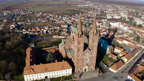People-Walking-In-The-Street-In-Front-Of-Dakovo-Cathedral,-A-Catholic-Church-In-Dakovo,-Slavonia,-Croatia