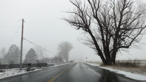 POV-footage-of-driving-in-the-countryside-of-Boulder,-Colorado-during-a-snowstorm