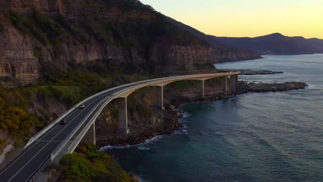 Twilight-View-Of-The-Beautiful-Sea-Cliff-Bridge-In-Illawarra-NSW,-Near-Sydney-Australia---aerial-drone-shot