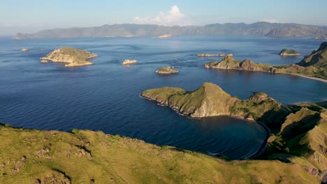 South-Padar-island-east-of-Komodo-Indonesia-with-calm-inlet-bays,-Aerial-pan-right-wide-shot
