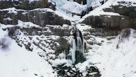 Dolly-out-aerial-drone-view-of-the-stunning-frozen-Stewart-Falls-waterfall-near-Sundance-Ski-Resort-in-Provo-that-requires-a-small-hike