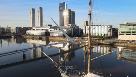Aerial-pan-of-Woman’s-Bridge-and-front-of-old-sailboat-in-Buenos-Aires