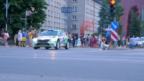 FIA-European-Rally-Trophy-2021-festive-start-and-cars-parade-at-streets-of-Liepaja-,-rally-cars-passing-spectators,-low-angle-tracking-shot