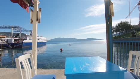 Table-at-seaside-cafe-overlooking-Aegean-Sea,-Bodrum,-Turkey,-Sunny-summer-day