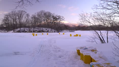 Bright-yellow-boxes-on-frozen-lake-for-ice-fishing-in-beautiful-nature-setting