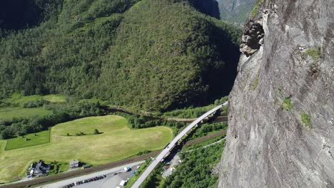 Flying-around-mountainside-cliffs-watching-Norwegian-infrastructure-with-highway-E16-in-between-Bergen-railway-and-old-rural-road---Spectacular-aerial-from-high-altitude-with-nature-background
