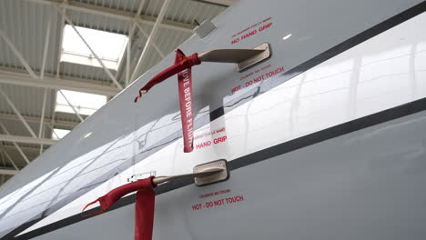Steady-gimbal-movement-around-jet-plane,-covered-pitot-tube-in-hangar
