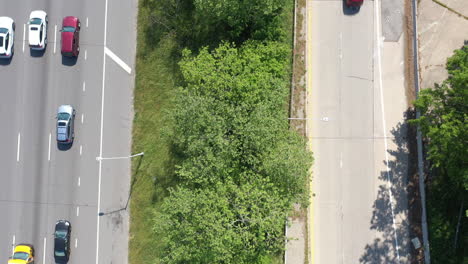 A-top-down-view-over-a-parkway-median-with-green-trees-and-grass
