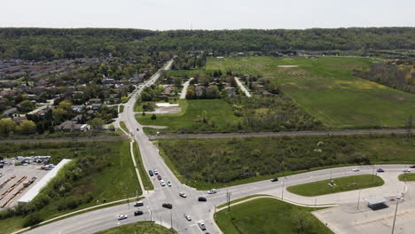 Aerial-backwards-shot-showing-traffic-on-junction-on-Canadian-highway-near-Hamilton-in-summer