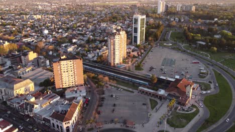 Aerial-view-showing-train-station-of-Tigre-City-beside-housing-complex-during-sunset