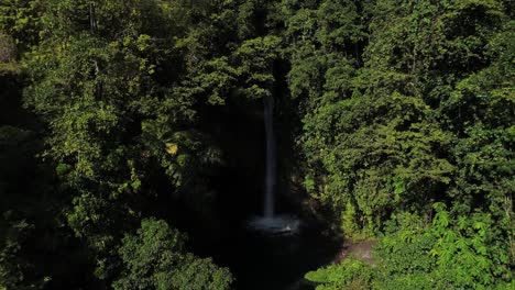 Aerial-of-Tuasan-waterfall-in-lush-green-jungle-of-Philippines,-tropical