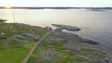 Rocky-Seawall-At-The-Island-Of-Store-Torungen-During-Golden-Sunset-In-Agder-County,-Norway
