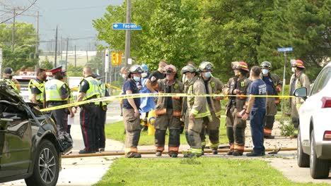 Firefighters-and-policemens-discussing-at-a-vehicle-accident