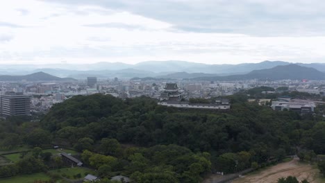 Aerial-view-of-Wakayama-castle-and-City-on-the-horizon,-Kansai-Japan