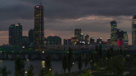 Seoul-at-NIght---63-Building-Skyscraper-With-Han-river-Railway-Bridge-In-Foreground-In-Seoul,-South-Korea
