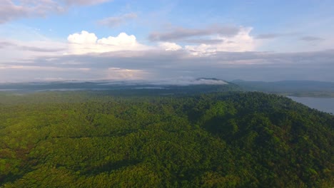 Ascending-Flight-over-Dense-Jungle-Covered-Island-of-Coiba-with-Cloud-Formation-Background