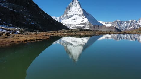 Descending-shot-of-Matterhorn-and-blue-Stellisee-lake