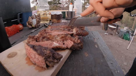 Cutting-a-steak-outdoors