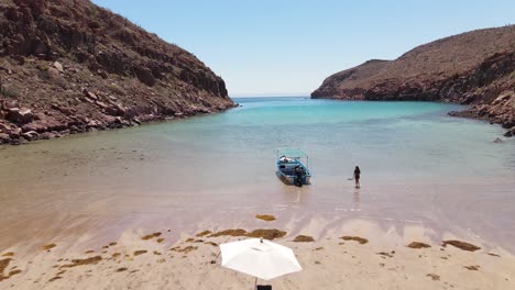 Aerial:-private-boat-beach-party-on-remote-island-Espiritu-Santo-at-Mexican-coastline,-Baja-California