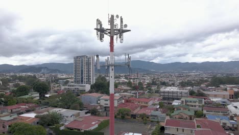 Aerial-shot-orbiting-a-cell-tower-in-the-city-of-San-Jose,-Costa-Rica
