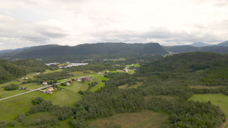 Aerial-flyover-green-landscape-with-green-trees-on-Averoy-Island-in-Norway