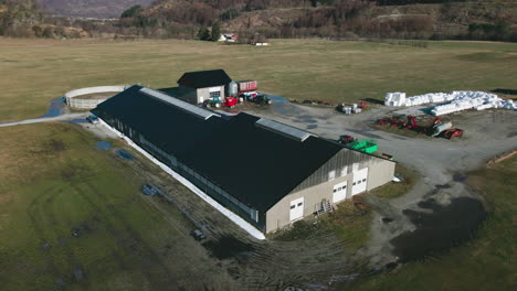 Dairy-Barn,-Silo,-And-Enclosure-For-Milk-Production-On-Agricultural-Landscape-In-Norway
