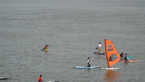 People-Windsurfing-And-Paddleboarding-At-Hangang-River-during-Summer-In-Seoul,-South-Korea