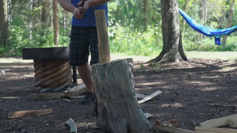 Male-Camper-Uses-Hatchet-In-Chopping-Wood-For-Outdoor-Cooking-In-The-Forest