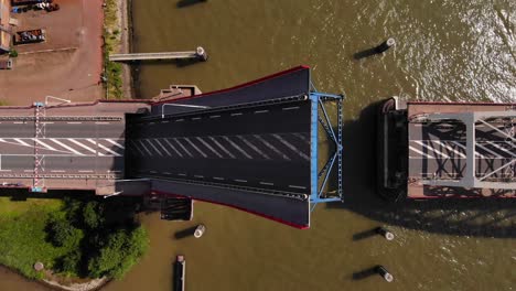 Top-View-Of-A-Single-leaf-Bascule-Bridge-Slowly-Opening-Over-Noord-River-In-Alblasserdam,-Netherlands
