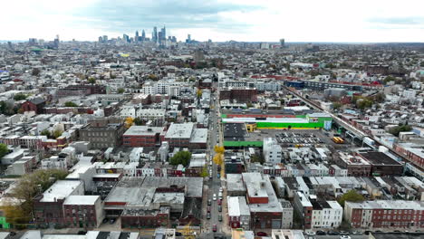 Aerial-of-Kensington,-North-Philadelphia-with-city-skyline-in-distance