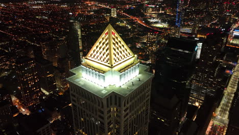 Cinematic-aerial-of-skyscraper-tower-at-night