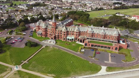 Aerial-view-of-Slieve-Donard-Resort-and-Spa-in-Newcastle-on-a-sunny-day,-County-Down,-Northern-Ireland