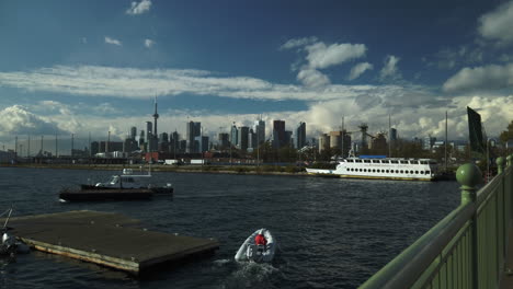Wide-shot-of-busy-boat-traffic-on-the-ship-channel-in-Port-Lands-of-Toronto