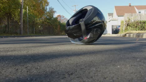 Wide-of-a-Motorcycle-Helmet-Rolling-on-a-Street