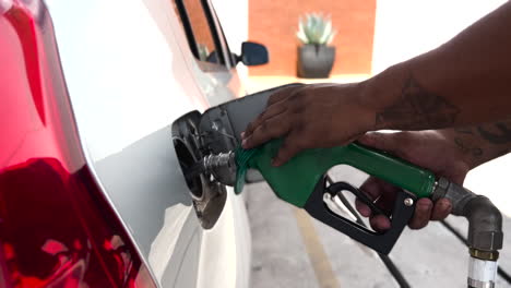 Hands-Remove-Alternative-Gas-Nozzle-From-Ethanol-Powered-Car-Reservoir