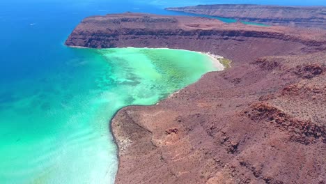 Slow-Ascending-Aerial-View-of-Desert-Island-near-Clear-Blue-Seascape
