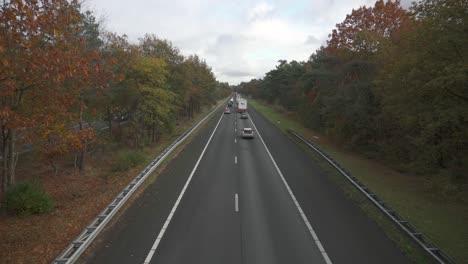 Autumnal-Trees-Surrounded-The-Traffic-Jam-On-A28-Highway-During-Autumn-Season-In-Netherlands
