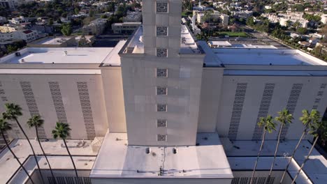 The-Temple-of-the-Church-or-Jesus-Christ-of-Latter-day-Saints-in-Los-Angeles,-California---ascending-aerial-view-from-the-entrance-to-the-golden-statue-on-the-steeple