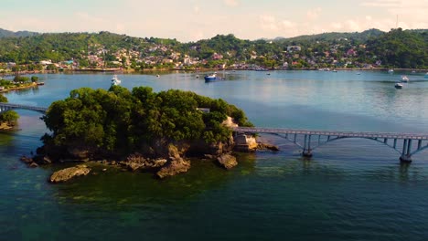 Samana-bay-with-pedestrian-bridge-to-nowhere,-aerial-side-flying-view