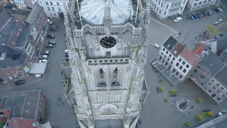 Close-Up-Clock-and-Bell-Tower,-Basilica-of-Our-Lady-in-Tongeren-AERIAL